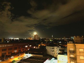 High angle view of illuminated buildings in city at night