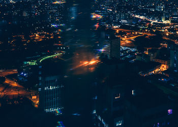 High angle view of city lit up at night