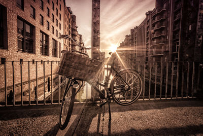 Bicycle in basket against building in city