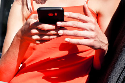 Midsection of woman using mobile phone