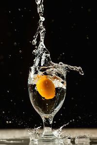 Close-up of wet splashing water against black background