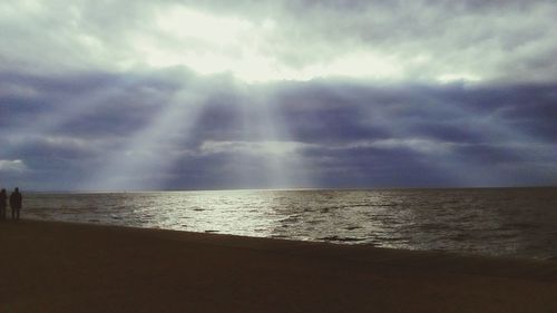 Scenic view of beach against sky during sunset