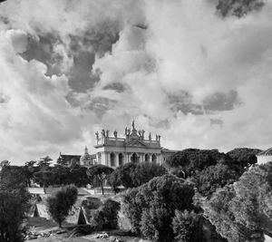 Buildings against cloudy sky