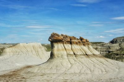 Rock formations on landscape against sky