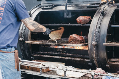 Man working on barbecue grill