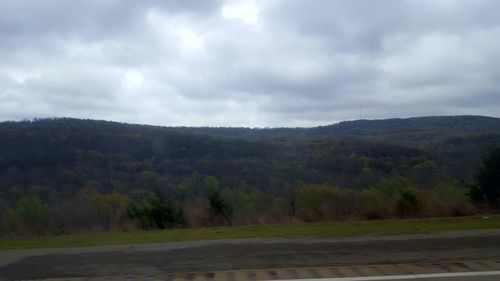 Scenic view of landscape against cloudy sky