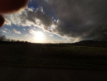 Scenic view of field against sky during sunset