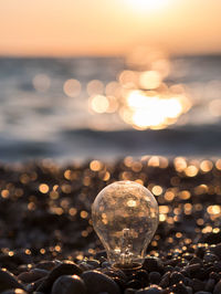 Defocused image of illuminated lights at sunset