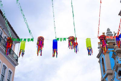 Low angle view of flags hanging against sky