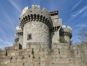 Low angle view of fort against cloudy sky
