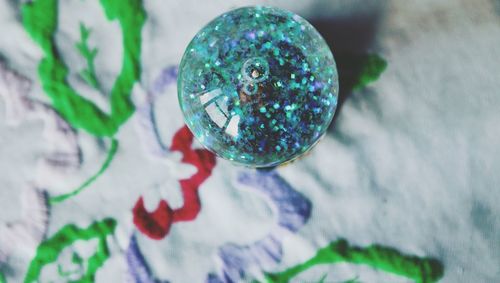 Close-up of multi colored ball on glass