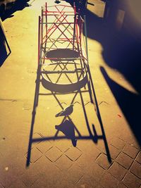 Low section of shadow on tiled floor