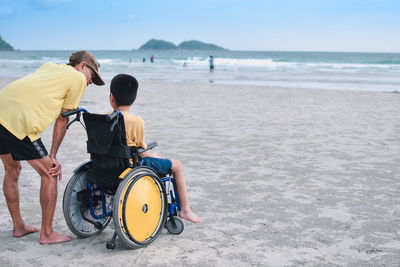 Rear view of people on beach