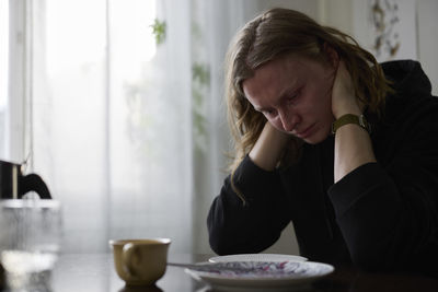 Sad woman sitting at table