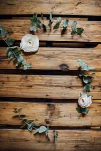 Directly above shot of flowers and leaves on wooden table