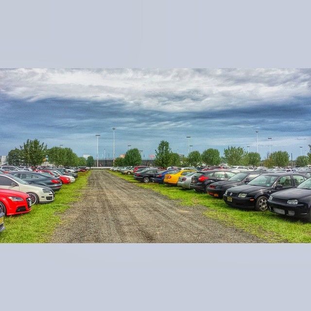 transportation, car, land vehicle, mode of transport, road, sky, street, the way forward, cloud - sky, diminishing perspective, road marking, vanishing point, cloudy, on the move, tree, travel, vehicle, cloud, windshield, outdoors