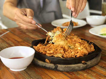 Cropped hand of person preparing food