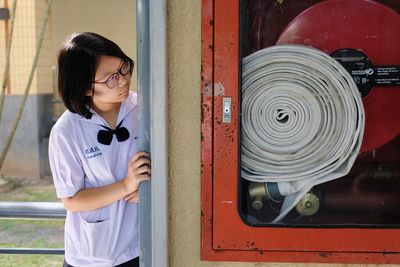 Smiling looking at fire hose