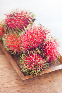 Close-up of rambutans in tray on table