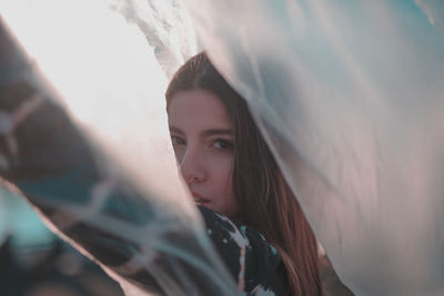 Close-up portrait of young woman with plastic