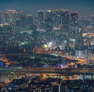 Aerial view of illuminated buildings in city at night