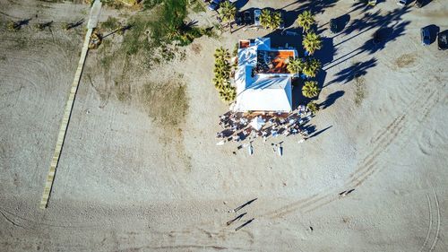 High angle view of people by restaurant at beach on sunny day