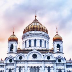 Low angle view of church against cloudy sky