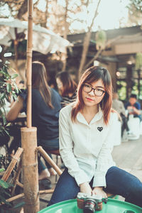 Young woman sitting outdoors