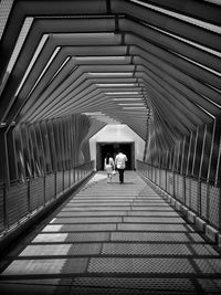 Rear view of people walking in building