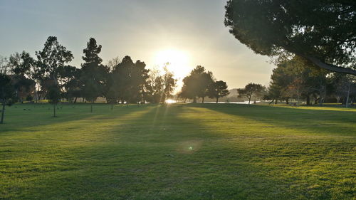 View of golf course against sky during sunset