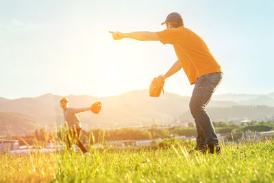 Father and son playing in baseball. man teaching boy baseballs exercise. family sports father's day.