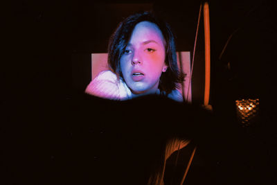 Portrait of woman in darkroom