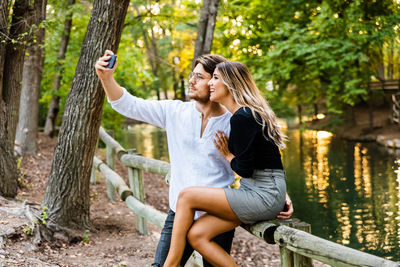 Couple taking selfie by railing