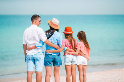 People standing on beach against sea