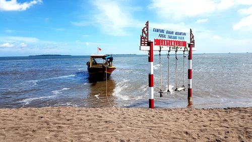 Lifeguard hut on beach against sky