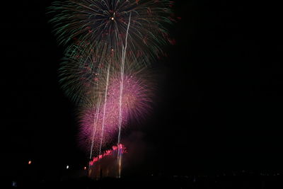 Low angle view of firework display at night