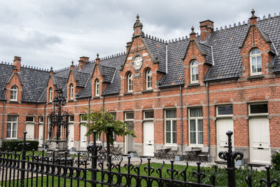 Buildings against cloudy sky