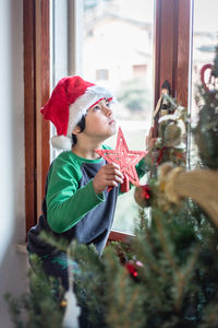 Young woman holding christmas tree