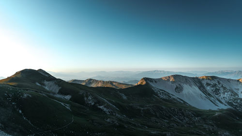 Scenic view of snowcapped mountains against clear sky