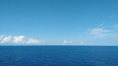 Scenic view of sea against blue sky