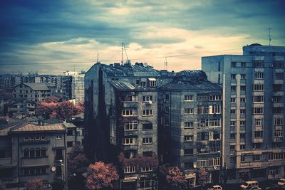 View of cityscape against cloudy sky