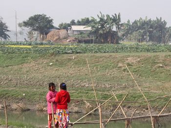 Two young girls seen strolling through the village, keeping each other accompanied 