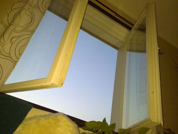 Low angle view of yellow window against clear sky