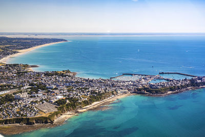 High angle view of sea and cityscape against sky