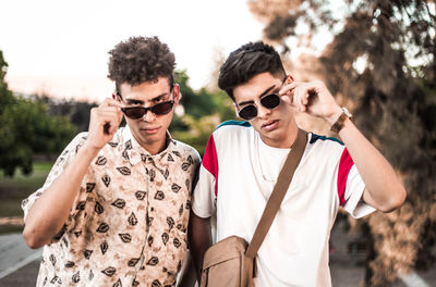 Portrait of young men wearing sunglasses
