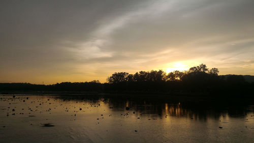 Scenic view of lake against sky during sunset