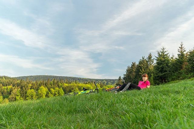 grass, sky, field, landscape, green color, tranquil scene, growth, cloud - sky, beauty in nature, leisure activity, tranquility, lifestyles, nature, scenics, cloud, grassy, rural scene, person