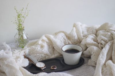 Close-up of white roses on table at home
