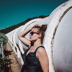 Side view of woman standing against sky