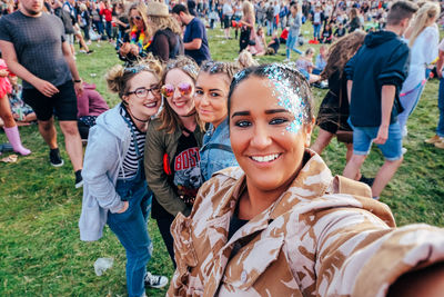 Portrait of smiling friends in music festival